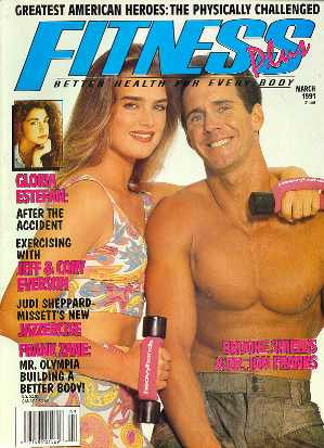 A man and woman posing for the cover of fitness magazine.